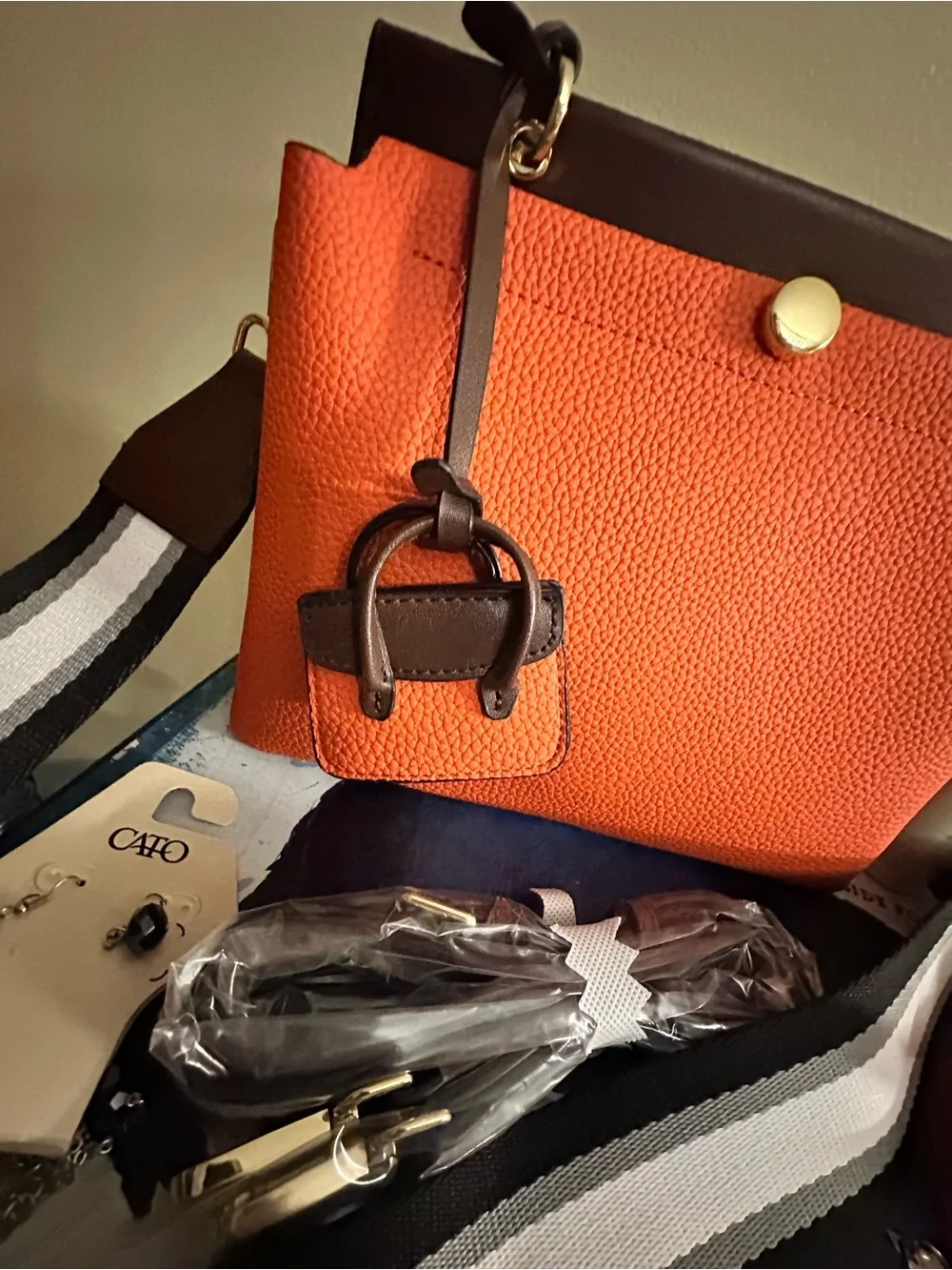 Orange hand Bag with Dark Brown Trim two crossbody straps..filled